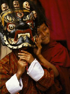 Young Bhutanis with traditional mask.