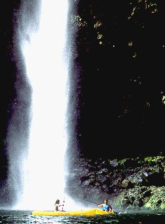 Kayaking by a waterfall.