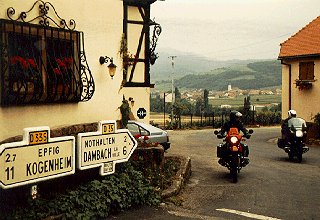 Bikers pass through a quaint German town.