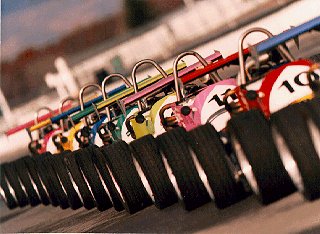 Cars line the track at the raceway.