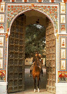 Rider pauses under a decorated arch.