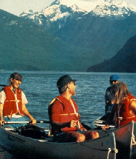 Paddling on Ross Lake with the Cascades behind.