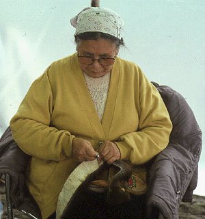 An Athabascan woman works on crafts.
