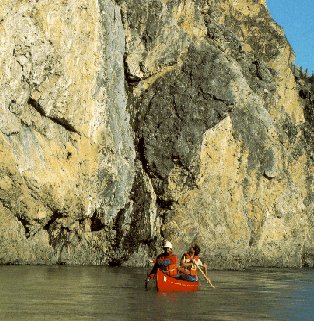 Rugged mountains contrast with placid water.