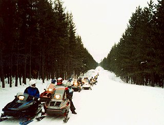 Snowmobilers enjoy wide national forest trails.