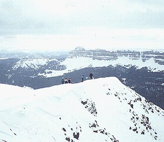 Snowmobiles perched atop a ridge near Yellowstone.